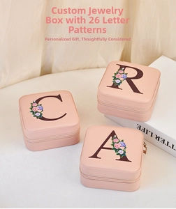 Detail view of pink PU leather jewelry box with floral letter and gold metal zipper