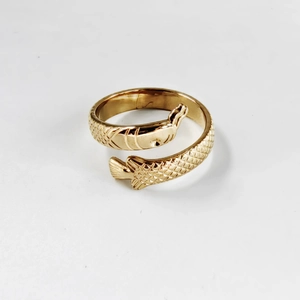 Macro shot of golden fish ring detailing intricate scale textures and metallic finish