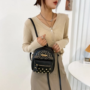 Punk style black mini backpack with gold studs and integrated headphone port for women