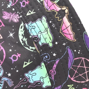 Close-up of the gothic bat and moon print on the black canvas bucket hat fabric
