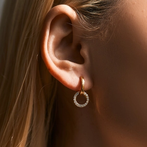 Elegant gold double hoop earrings with micro-set zircon crystals on a female model