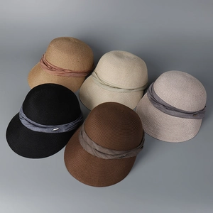 Detailed view of woven straw sun hats in five colors with pleated fabric bands