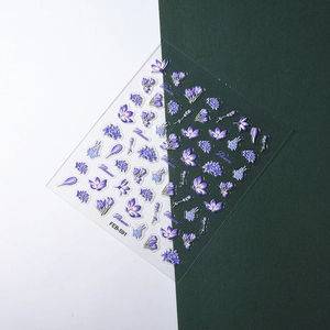 Macro detail of 3D embossed purple flower nail art stickers with realistic petal texture