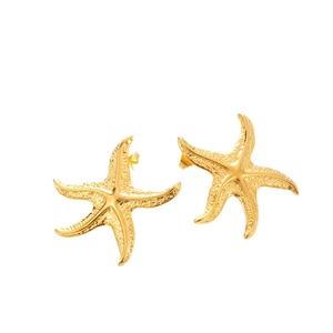 Textured gold starfish stud earrings made of stainless steel on a white background