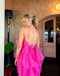 Detail of bright pink layered ruffle dress with back tie-up and thin shoulder straps