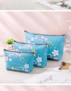 Three-piece floral PU makeup bag set in blue with gold zippers for travel organization