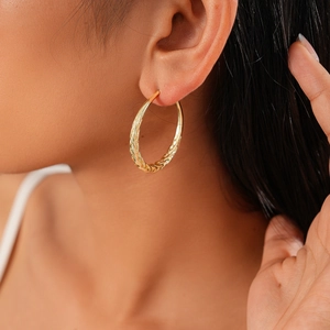 Minimalist gold geometric twist earrings shown on model for elegant daily style