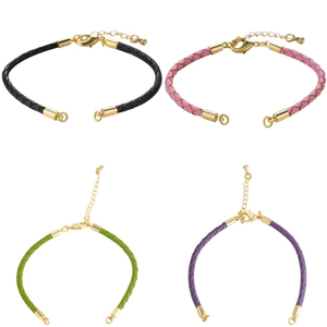 Detail of woven rope bracelets in black, pink, green, and purple with gold lobster clasps