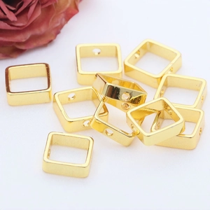 Close-up of 14K gold filled square bead frames for DIY jewelry making accessories