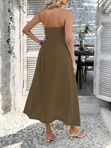 Detail view of the backless halter design on a long solid brown-green summer maxi dress