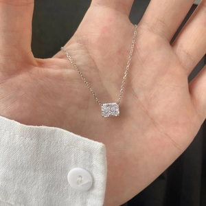 Detail of s925 silver necklace with rectangular cut moissanite pendant in hand view