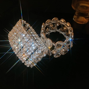 Close-up of luxury silver stretch bracelets with hand-set pavé rhinestones in dark setting