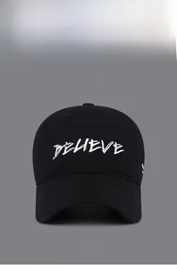 Detail of Believe letter embroidery on black vintage baseball cap with cotton texture