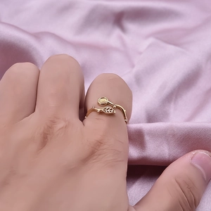 Elegant gold leaf 304 stainless steel open ring shown on a pink silk background