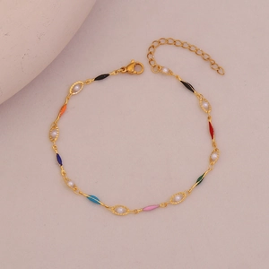 Detailed view of golden anklet featuring colorful enamel hearts and white pearls