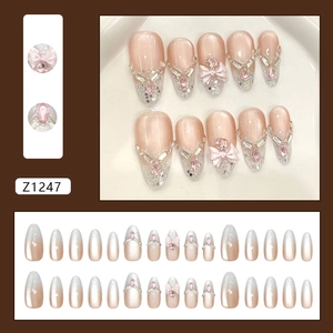 Uñas postizas rosa cat eye con degradado de purpurina y lazo decorativo de diamantes