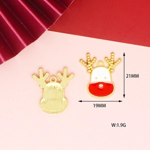 Detail of reindeer alloy charms in gold finish with red and white enamel for DIY jewelry
