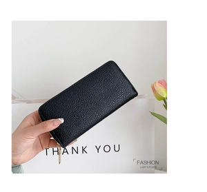 Close-up of black lychee grain PU leather long wallet with golden zipper detail