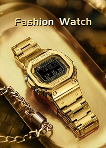 Macro shot of gold-plated digital watch on a luxury tray showing detail and finish