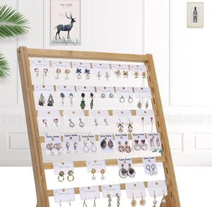 Detail of tiered bamboo jewelry stand with multi-layer racks for earring card display
