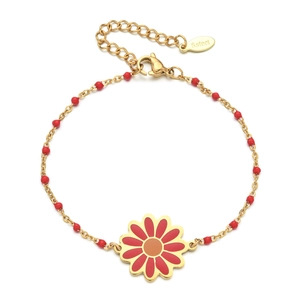 Detail of a stainless steel gold bracelet with red beads and a daisy flower charm