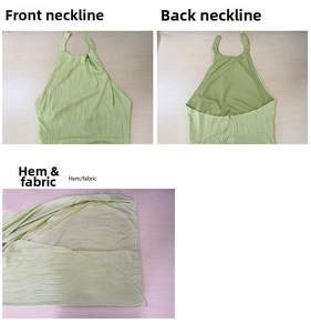Detail of light green halter dress showing textured fabric, back zipper and hem stitching