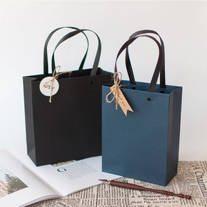 Elegant gift bags with black silk handles and decorative Love and Thank You tags