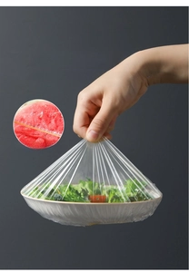 Elastic food covers sealing a salad bowl and watermelon with strong double bands
