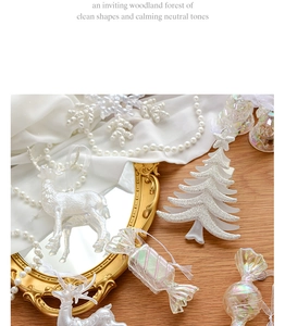 Detailed arrangement of white flocked deer and glitzy acrylic tree on elegant silk