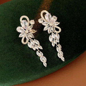 Close-up of sparkling silver floral tassel earrings with marquise and pear shaped gems