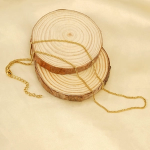 Classic gold stainless steel curb chain necklace with lobster clasp on wooden slices