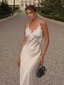 Close-up of champagne satin maxi dress featuring delicate white lace trim on the bodice
