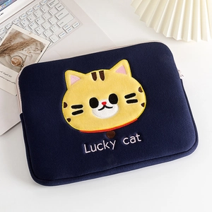 Detail of cute yellow cartoon cat embroidery and Lucky cat text on navy laptop sleeve