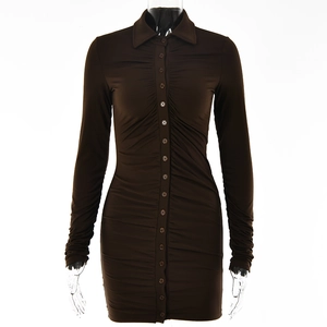 Detail view of brown long sleeve buttoned dress with ruched texture on mannequin