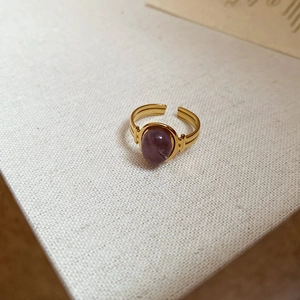 Close-up of 18k gold plated stainless steel ring with oval purple amethyst stone