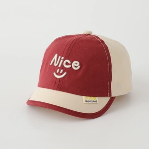 Detailed close-up of nice smiley face embroidery on a kids contrast baseball cap