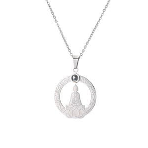 Macro view of stainless steel lotus pendant with seated Buddha silhouette and projection stone