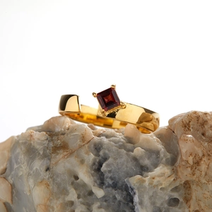 Close-up of a gold 18K plated S925 silver ring with a square red garnet on stone