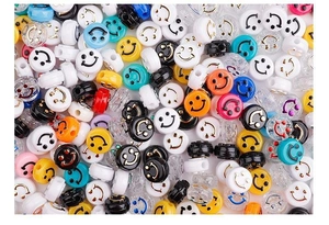 Macro shot of colorful acrylic smiley face flat round beads for DIY jewelry making