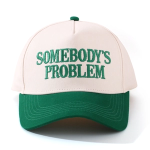 Close-up of SOMEBODY'S PROBLEM embroidery on two-tone cotton baseball cap with flat brim