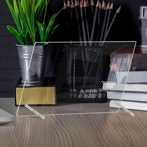 Detailed view of clear acrylic weekly planner board with silver metal stands on desk