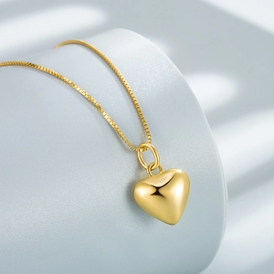 Vintage 925 sterling silver 18k gold heart pendant necklace on minimalist display