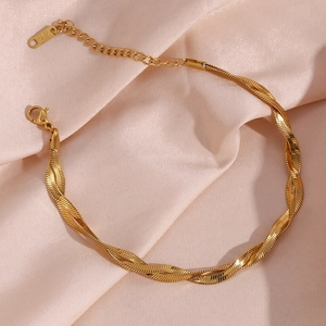 Detail of 18K gold-plated double-strand blade chain anklet with lobster clasp on silk