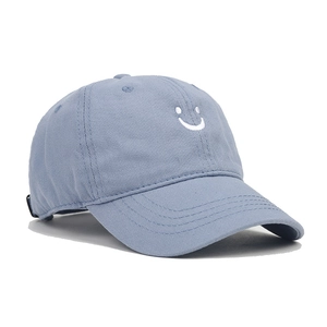 Detailed side view of cotton baseball cap with embroidered smile and curved brim