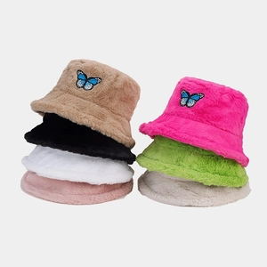 Detail view of plush fisherman hats in multiple colors featuring butterfly embroidery