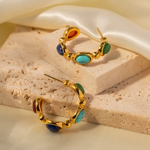 Retro C-shaped 18K gold plated earrings with colorful natural stones on silk background