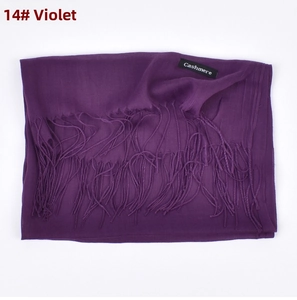 Detail of violet cashmere scarf showing soft texture, fringe edges and material tag