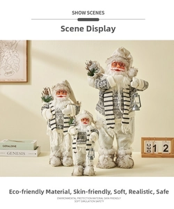 Three Nordic Santa dolls in different sizes with lanterns and grey snowflake knitwear