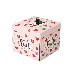 Pink heart patterned surprise explosion gift box with luck text and black ribbon handle