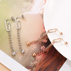 Detail view of long tassel earrings with link chain and polished ball drops in two colors